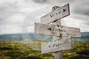 why follow path text engraved on old wooden signpost outdoors in nature