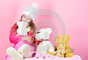 Why kids love stuffed animals. Kid little girl play with soft toy teddy bear on pink background. Toy every child