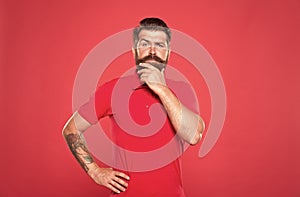 Why so serious. Serious look of brutal hipster. Bearded man think red background. Serious and thoughtful. Thinking on