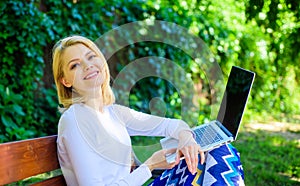 Wi fi network connection free access. Lady freelancer working in park. Woman with laptop works outdoor, green nature