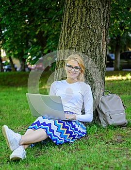 Wi fi network connection free access. Lady freelancer working in park. Woman with laptop works outdoor, park background