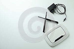 Wi-Fi router with external antennas and plug on white background