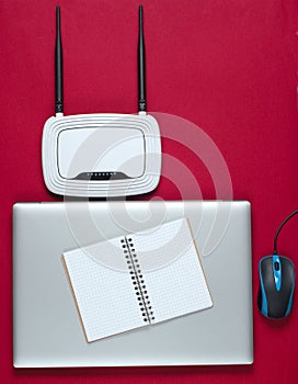 Wi fi router, laptop, pc mouse, notepad