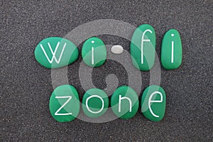 Wi-Fi Zone text with green colored stones over black volcanic sand