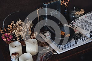 Wiccan witch altar prepared for casting a spell with an open Book of Shadows