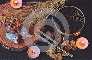 Wiccan witch altar prepared for sound healing magick with 741hz tuning fork and Tibetan singing bowl photo