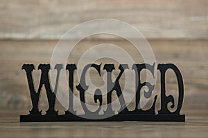 Wicked sign on wood background