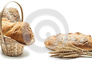 Wicker basket bread loafs banch of ears  on white