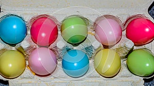 Wicker basket with colorful Easter eggs on wooden table