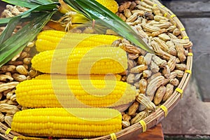 Wicker basket with corn cobs and raw peanuts