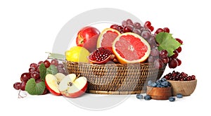 Wicker basket with different fruits and berries on white background