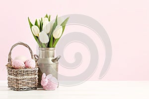 Wicker basket with Easter eggs and ceramic rabbit figure