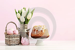 Wicker basket with Easter eggs and ceramic rabbit figure