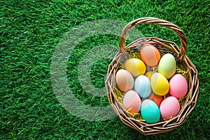 a wicker basket filled with colorful easter eggs on a lush green field