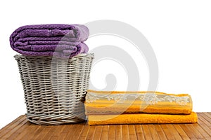 Wicker basket full of clean colored towels