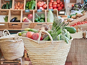 Wicker basket full of vegetables and fruits in a small local organic food store.