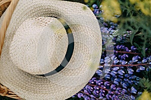 Wicker basket with hat and lupins
