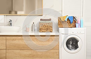 Wicker basket with laundry and detergents on washing machine