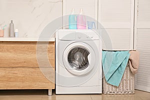 Wicker basket with laundry, detergents and washing machine