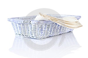 Wicker basket and napkin on white photo