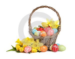 Wicker basket with painted Easter eggs and flowers