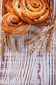 Wicker basket with raisin bakery goods wheat ears