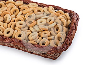 Wicker basket with ring-shaped cracknels sooshkas, little bagels. Isolated over white background, close-up, top view