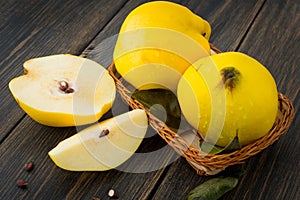 A wicker basket of yellow quince or queen apple autumn fruits, s