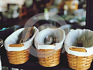 Wicker baskets with cutlery in a restaurant, stock photo