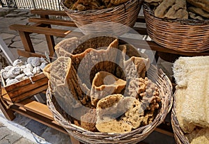 Wicker baskets filled with natural greek sponges at the gift shop, Symi island, Greece.