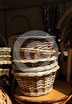 wicker baskets lie on a wooden chair. sale of handmade items