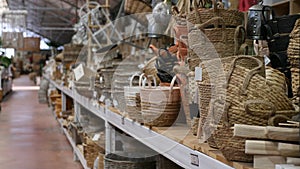 Wicker baskets and other handmade items on store shelves closeup