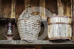 Wicker bottle of wine and wood barrel