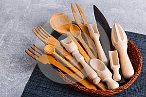 In the basket is a set of various kitchen devices are made of wood.