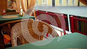 Wicker chair in an empty cafe. The camera moves