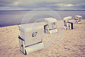 Wicker chairs on an empty beach.