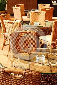 Wicker chairs and table in restaurant