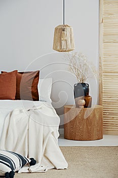 Wicker chandelier in classy bedroom interior in Scandinavian style