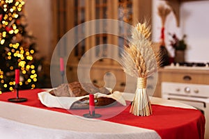 Ukrainian traditions, candles and bread on the table at Xmas. Ukrainian style interior kitchen with decor photo