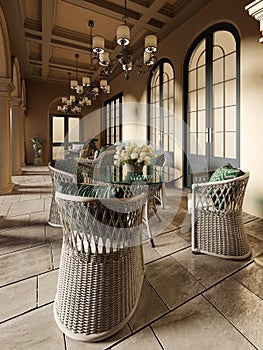 A wicker dining table with glass top and wicker chairs on a pillared terrace in the evening sun