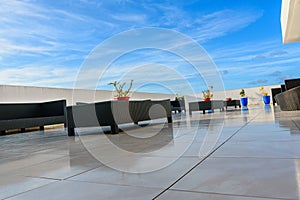 Wicker furniture on a concrete terrace of modern house