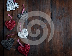 Wicker hearts on a brown wooden plank background