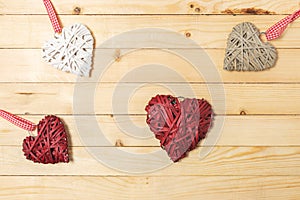 Wicker hearts made of straw on wooden background with copy space. Valentine day or love concept
