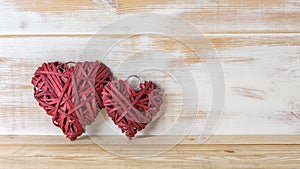 Wicker hearts made of straw on wooden background with copy space. Valentine day or love concept