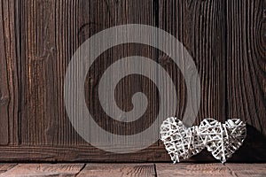 Wicker hearts on wooden background