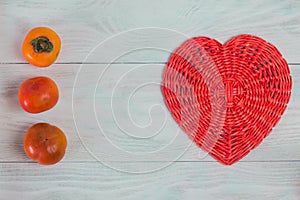 Wicker paper tube red heart on white wood boards, love and wedding concept, Valentine`s day, background