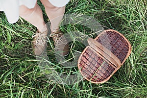 Wicker Picnic Basket On The Fresh Summer Grass Overhead View. Weekend Resting Concept