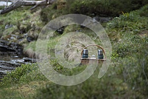 Wicker picnic hamper containing hot drinks flasks awaits thirsty walkers