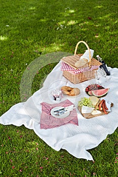Wicker picnic hamper with fresh food and wine
