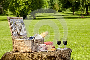 Wicker picnic hamper with wine and bread